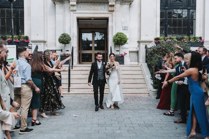 bride and groom walking out of the building